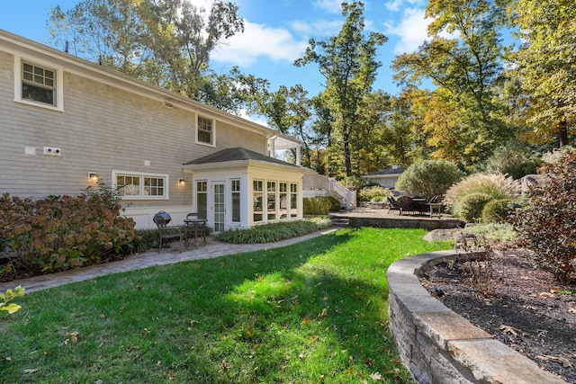 back of house with a patio, french doors, and a yard