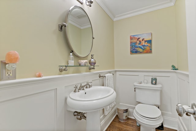 bathroom featuring sink, crown molding, wood-type flooring, and toilet