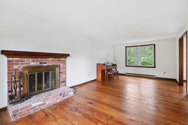 unfurnished living room featuring a baseboard heating unit, wood-type flooring, and a fireplace