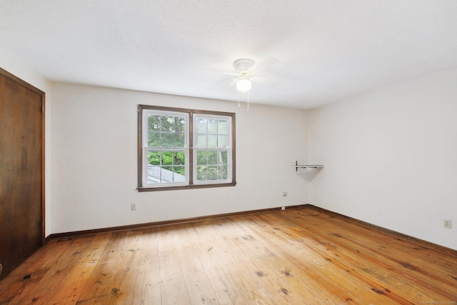 unfurnished bedroom featuring wood-type flooring, ceiling fan, and a closet