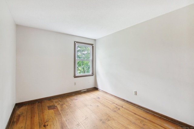 spare room featuring hardwood / wood-style flooring