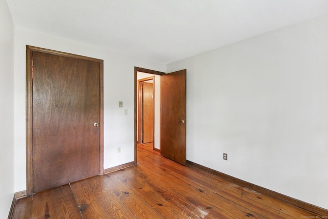 unfurnished bedroom with wood-type flooring