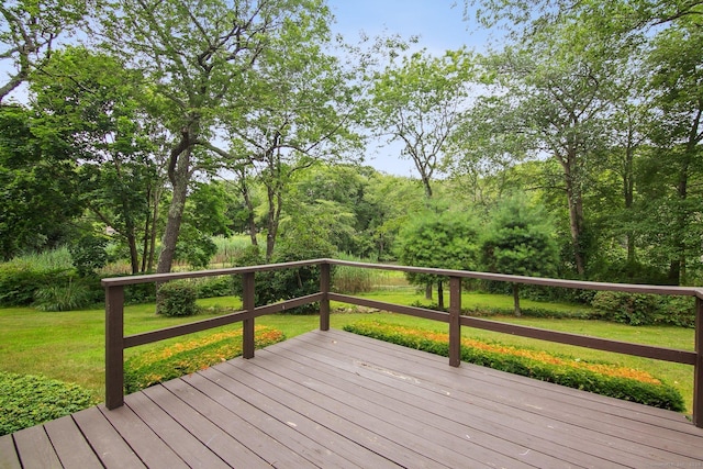 wooden terrace featuring a yard