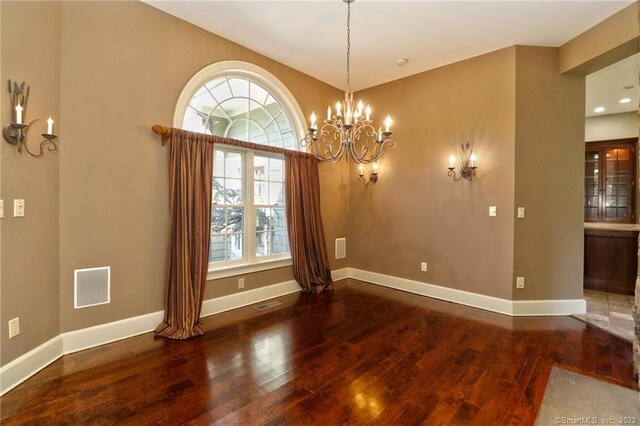 interior space with an inviting chandelier and dark wood-type flooring