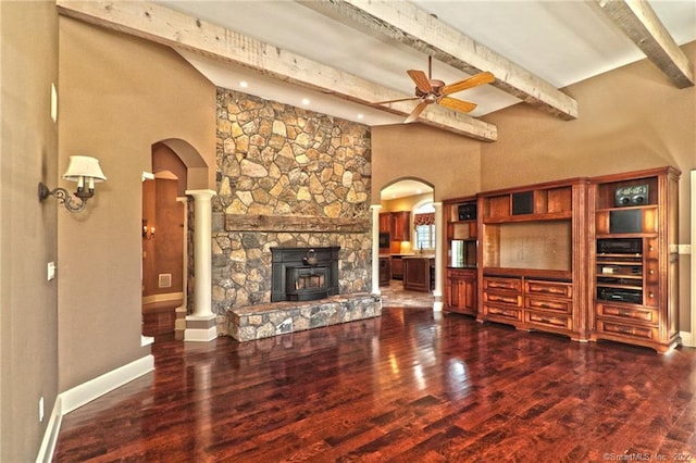 unfurnished living room with dark hardwood / wood-style floors, beamed ceiling, and a fireplace