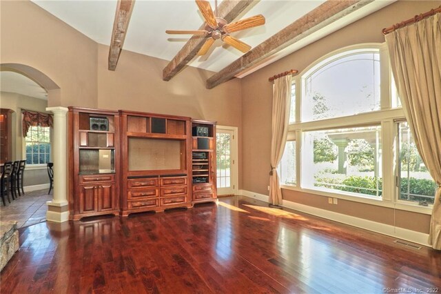 living room with beamed ceiling, a towering ceiling, hardwood / wood-style floors, and ceiling fan