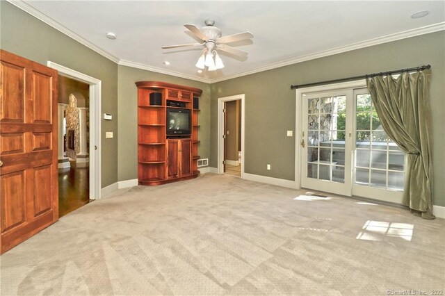 interior space featuring light carpet, ornamental molding, and ceiling fan