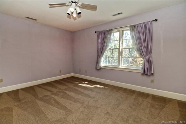 empty room featuring carpet and ceiling fan