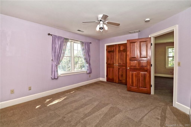 unfurnished bedroom featuring carpet flooring, a closet, and ceiling fan