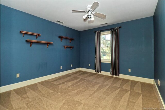 spare room featuring carpet floors and ceiling fan