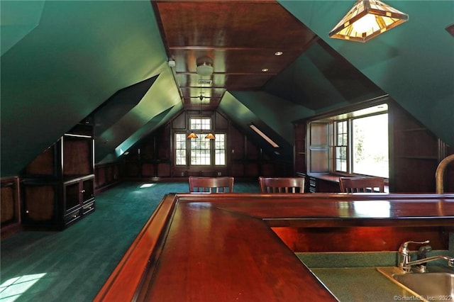 game room featuring vaulted ceiling, dark carpet, and sink