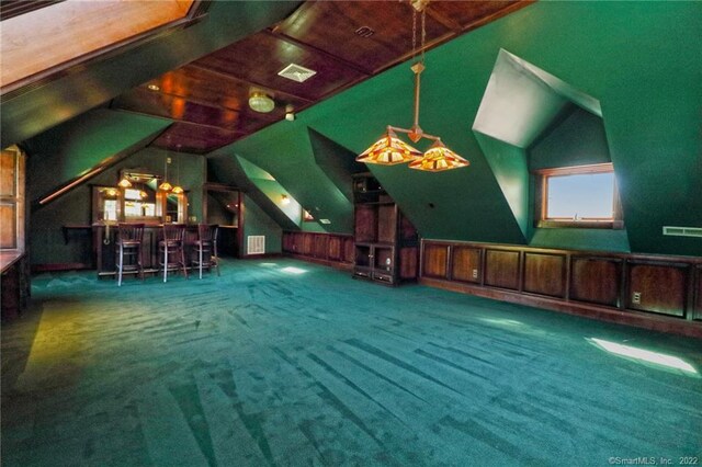 interior space featuring wood walls, vaulted ceiling, carpet, and wooden ceiling