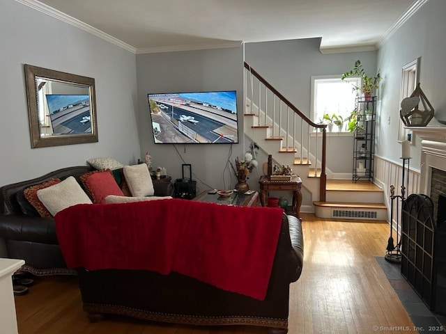 living room with hardwood / wood-style flooring and crown molding