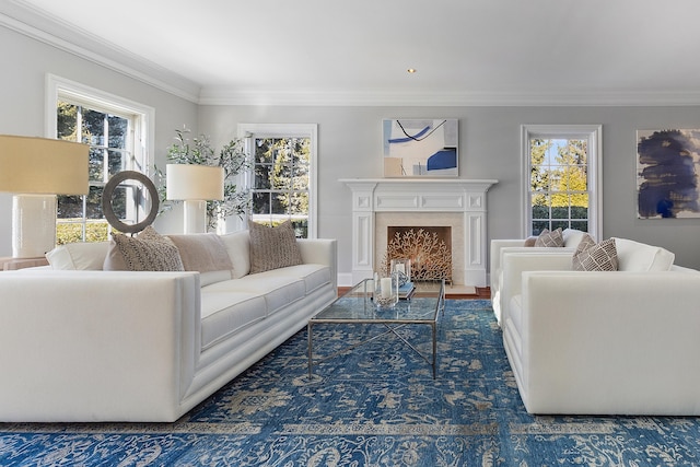 living room with crown molding, a premium fireplace, and a wealth of natural light