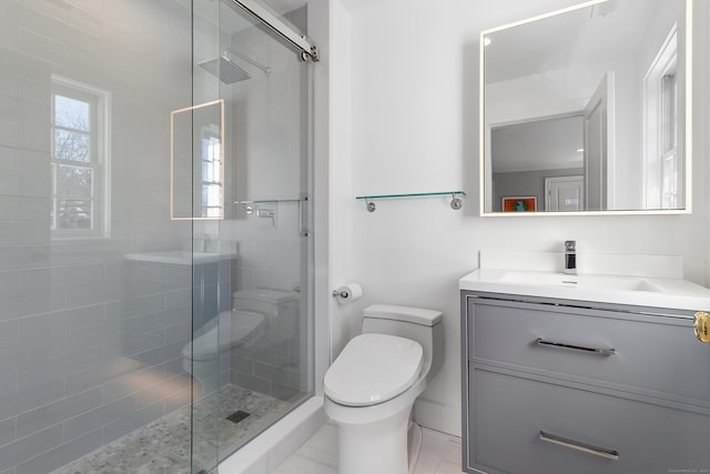 full bath with a tile shower, toilet, and vanity