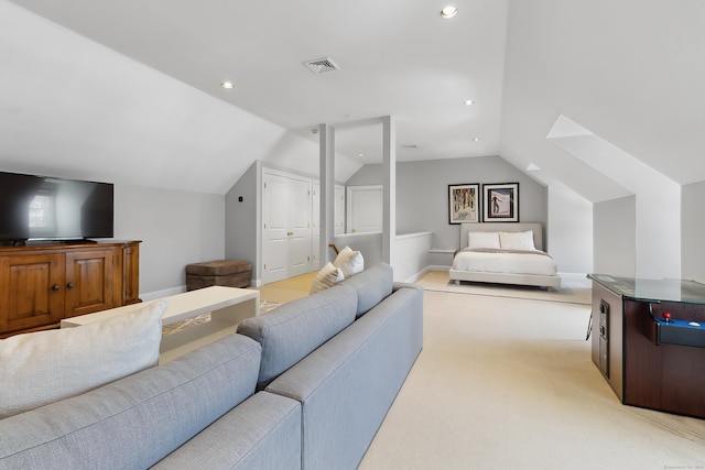 living area with light colored carpet, visible vents, vaulted ceiling, and baseboards