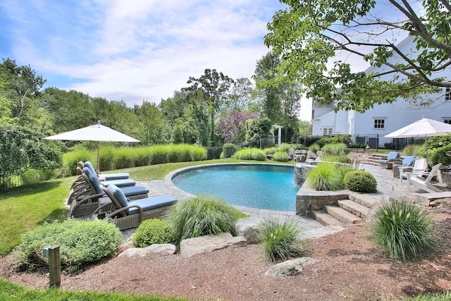 pool featuring fence and a patio area