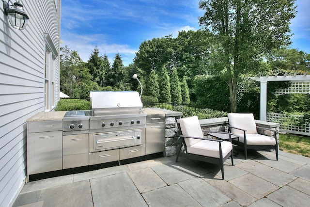 view of patio with exterior kitchen and grilling area