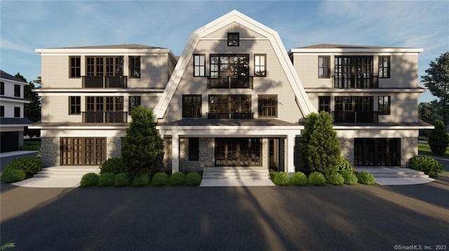 view of front of property featuring a balcony and a garage