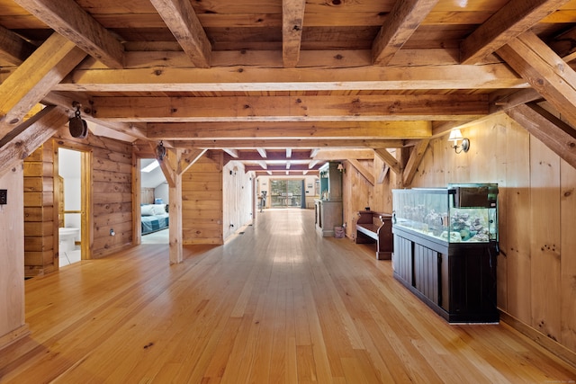 bonus room featuring beam ceiling, wood ceiling, wooden walls, and light hardwood / wood-style flooring