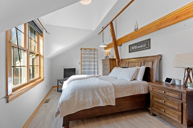 bedroom with lofted ceiling and light hardwood / wood-style flooring