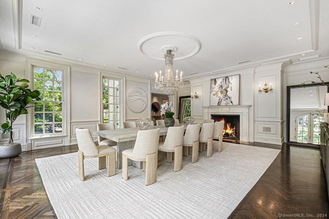 dining area with a chandelier, dark parquet floors, and crown molding