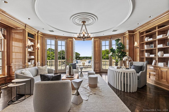 living area with french doors, built in features, parquet floors, and a notable chandelier