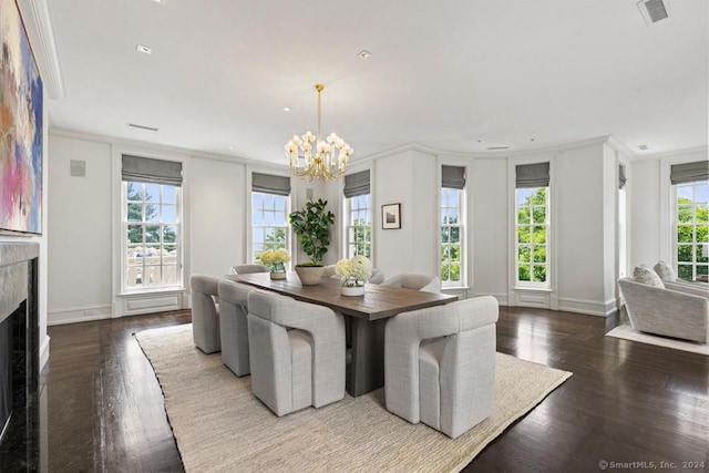 dining space with hardwood / wood-style flooring, a notable chandelier, and ornamental molding