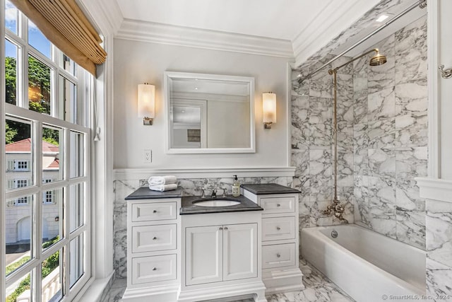 bathroom featuring vanity, tiled shower / bath, a healthy amount of sunlight, and tile walls