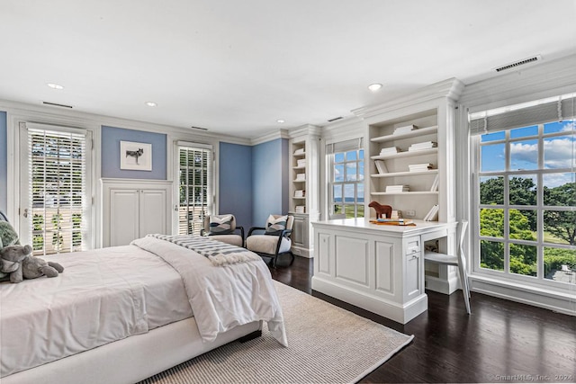 bedroom featuring dark hardwood / wood-style floors, crown molding, and multiple windows