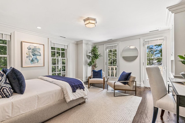 bedroom with dark hardwood / wood-style flooring and crown molding