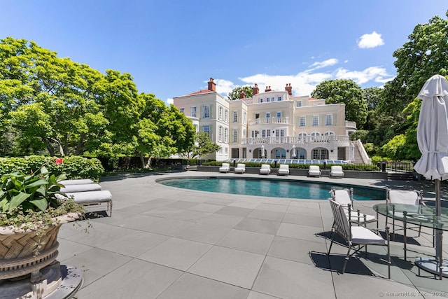 view of swimming pool featuring a patio area