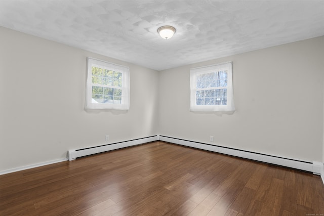 unfurnished room with a baseboard radiator, wood-type flooring, and a textured ceiling