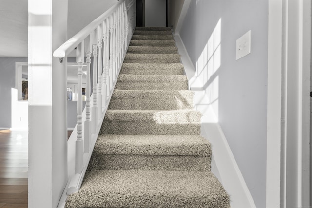 stairs with hardwood / wood-style floors