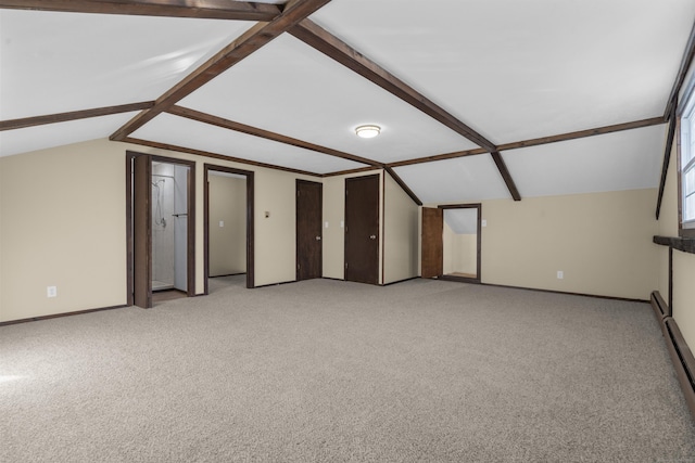 bonus room with light colored carpet and vaulted ceiling