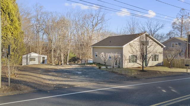 view of home's exterior with a garage and an outdoor structure