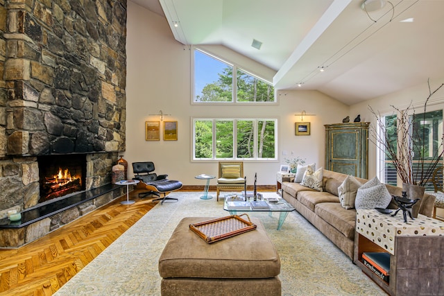 living room featuring a fireplace, high vaulted ceiling, and parquet flooring