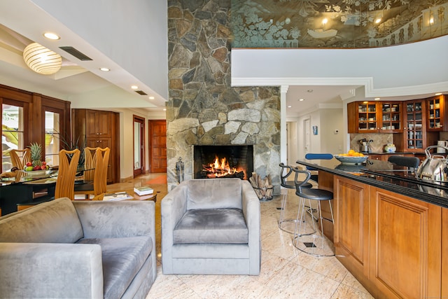 living room with crown molding and a fireplace