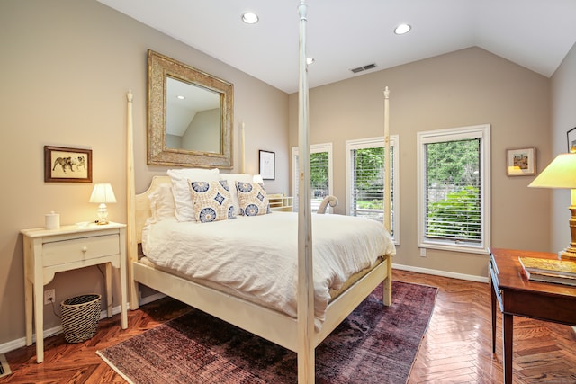 bedroom with lofted ceiling and parquet flooring