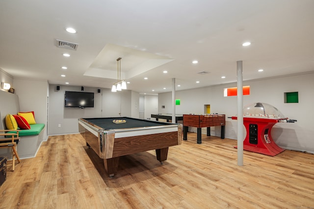 rec room featuring a raised ceiling, billiards, and light hardwood / wood-style flooring