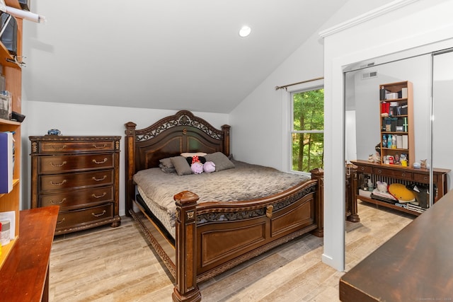 bedroom with light hardwood / wood-style flooring and lofted ceiling