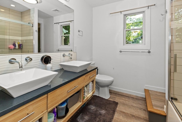 262 Great Plain Rd Unit 13, Danbury, CT 06810 - full bathroom with wood finished floors, double vanity, a tile shower, toilet, and baseboards
