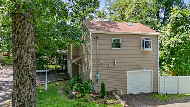 back of property featuring a garage