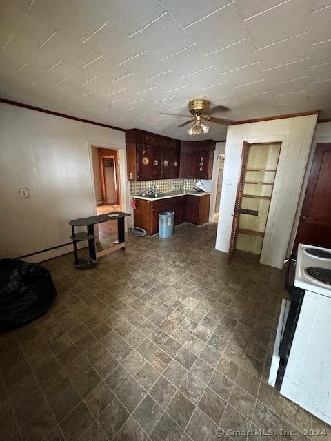 kitchen with ceiling fan, white range with electric cooktop, tasteful backsplash, and dark tile patterned flooring