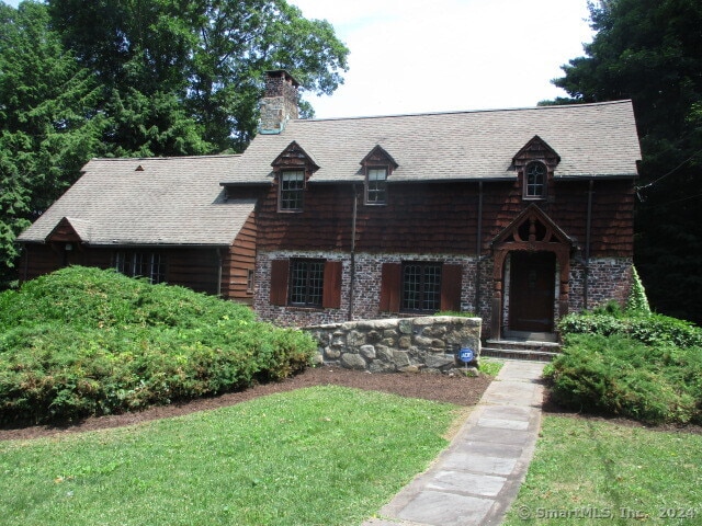 log-style house with a front lawn