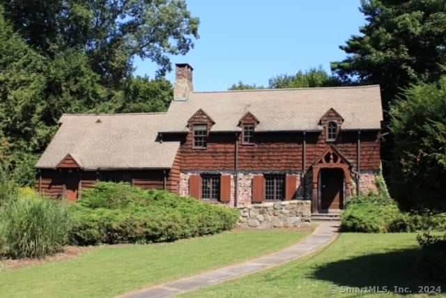 log cabin featuring a front lawn