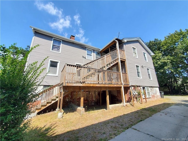 back of house featuring a deck