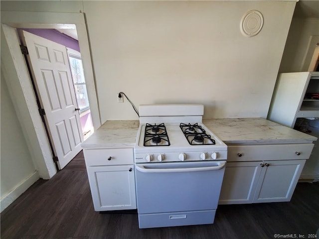 kitchen featuring white cabinets, gas range gas stove, and dark hardwood / wood-style floors