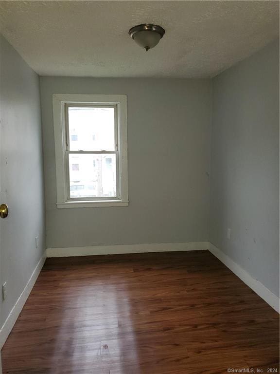 empty room with dark wood-type flooring