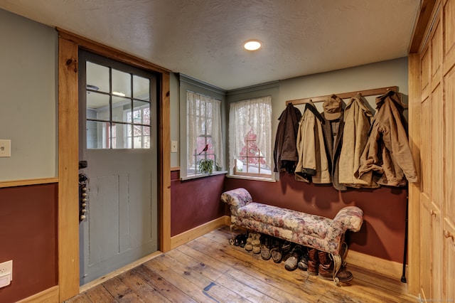 mudroom with light hardwood / wood-style flooring and a textured ceiling